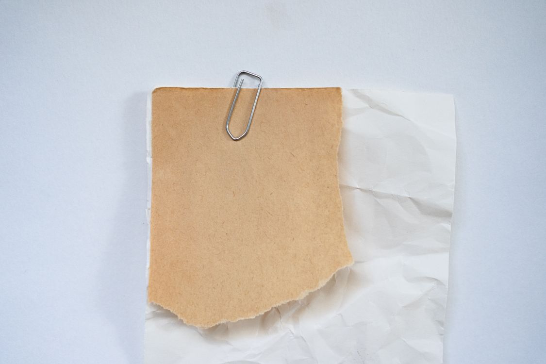 A piece of paper with a paper clip on it · Free Stock Photo
