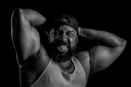 Free Powerful black and white portrait of a bodybuilder showcasing strength and determination. Stock Photo