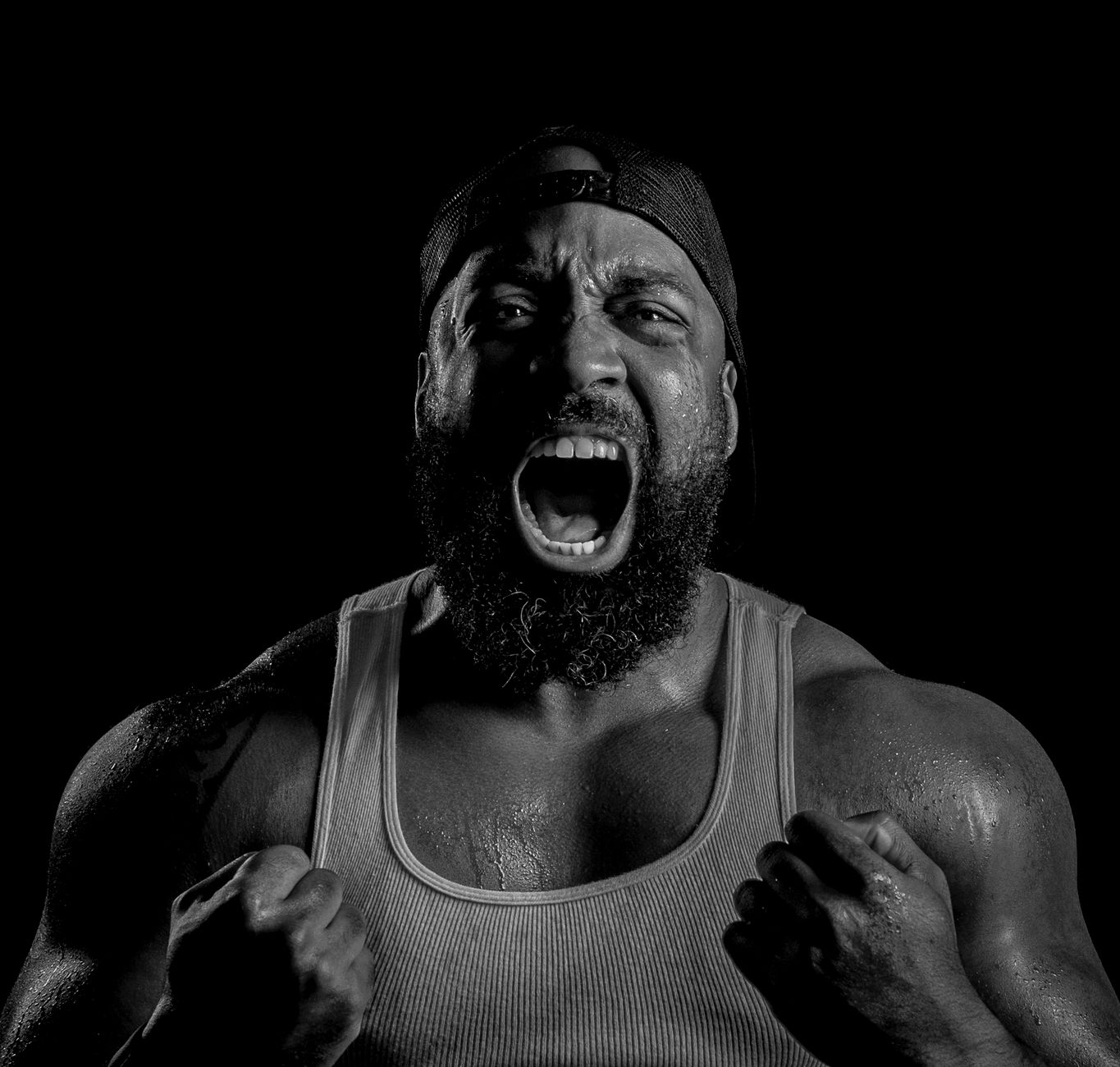 Dynamic black and white portrait of a strong, determined man showcasing power and intensity.