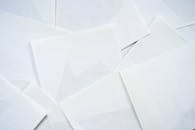 A pile of white envelopes on a table