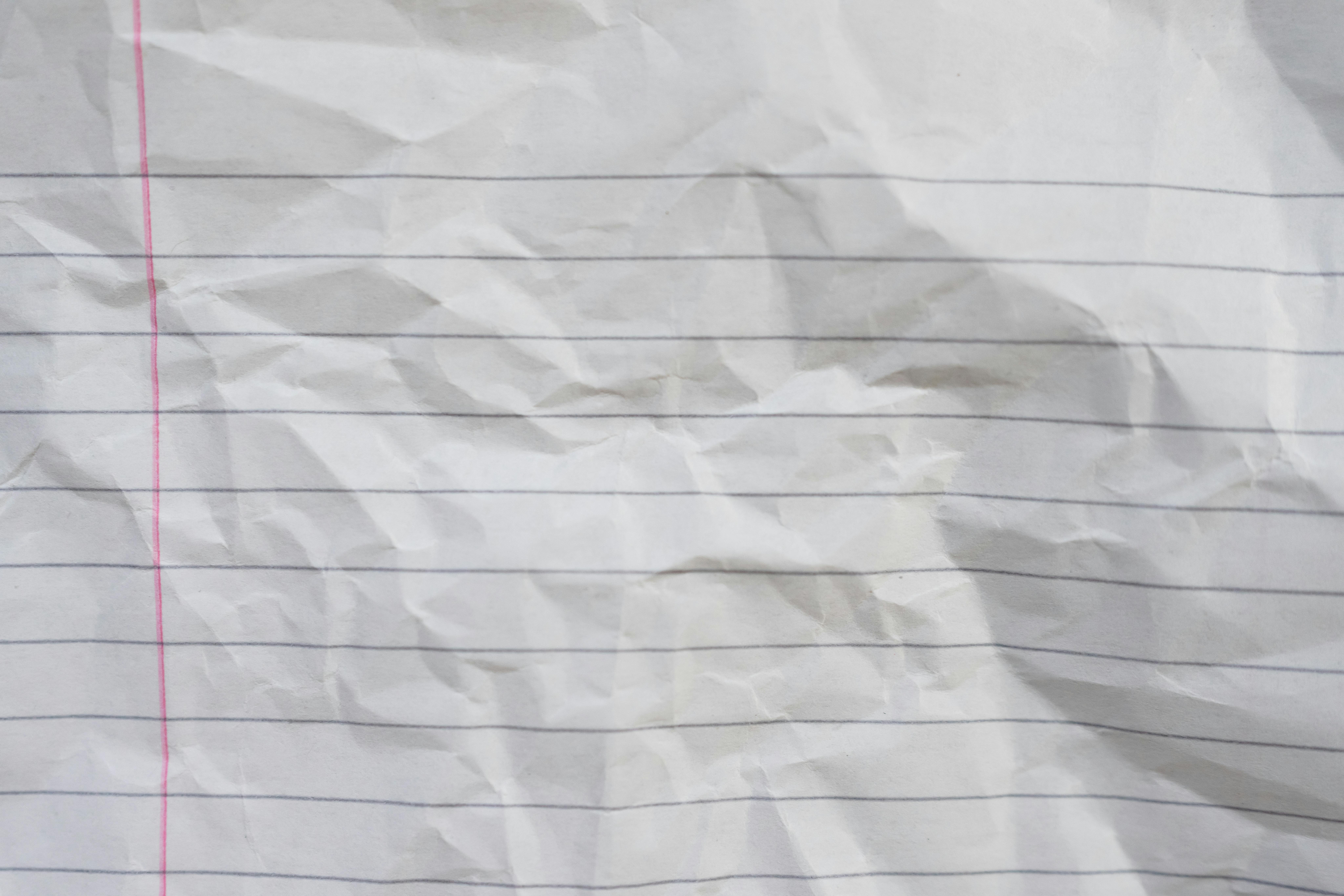 Free Crumpled lined paper showcasing texture, ideal for backgrounds and design projects. Stock Photo