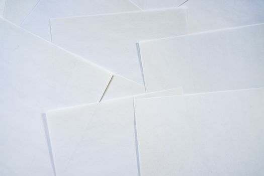 A pile of white paper with a few pieces of paper