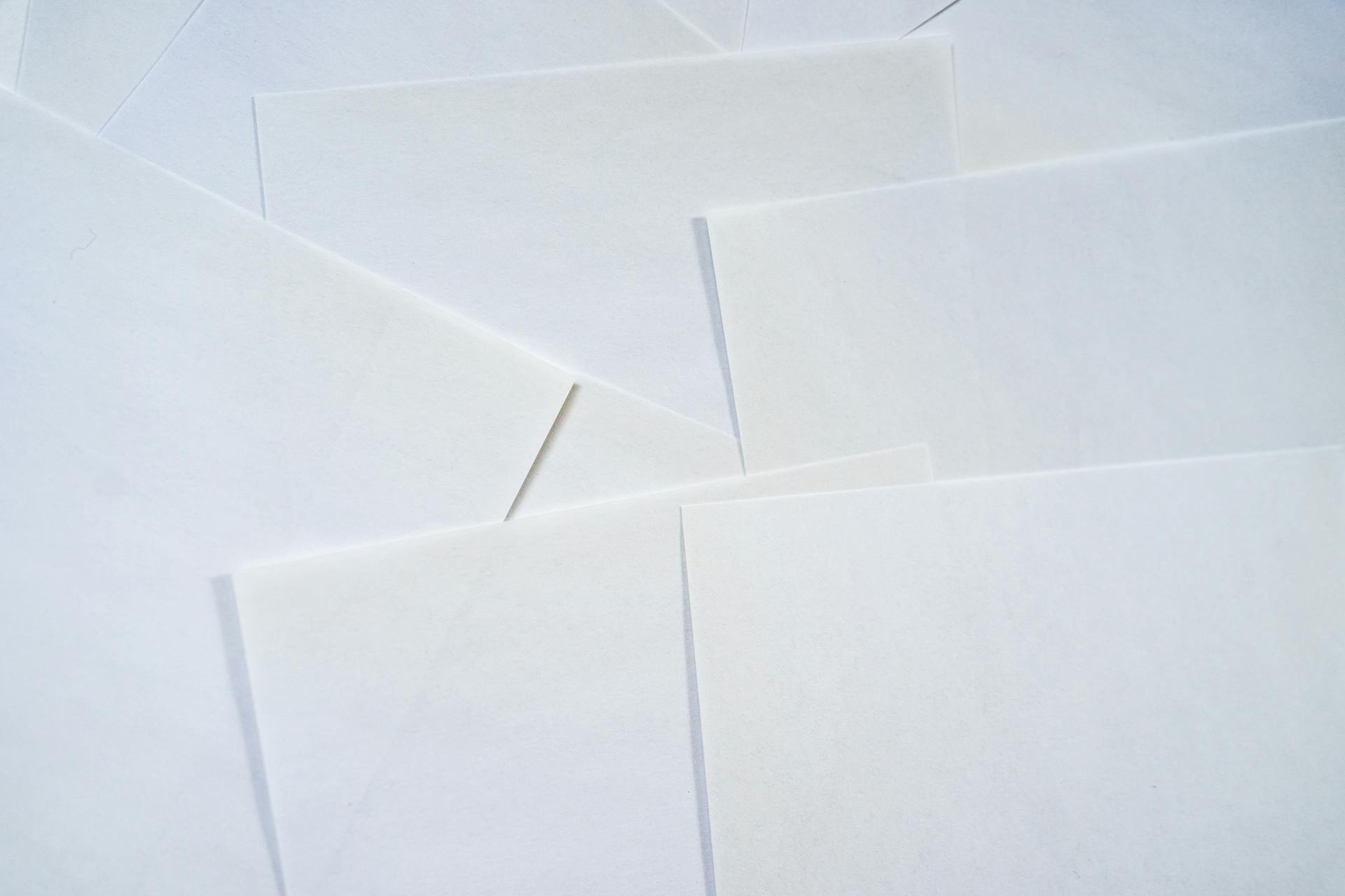 Abstract image featuring overlapping sheets of white paper creating geometric textures.