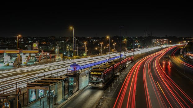 Dynamic city night scene featuring buses and light trails on a busy highway