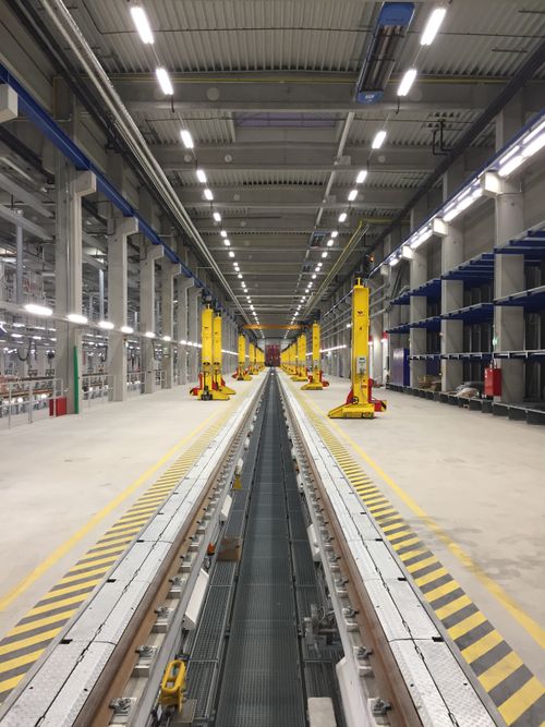 Free Spacious modern train maintenance facility with parallel tracks and industrial equipment. Stock Photo