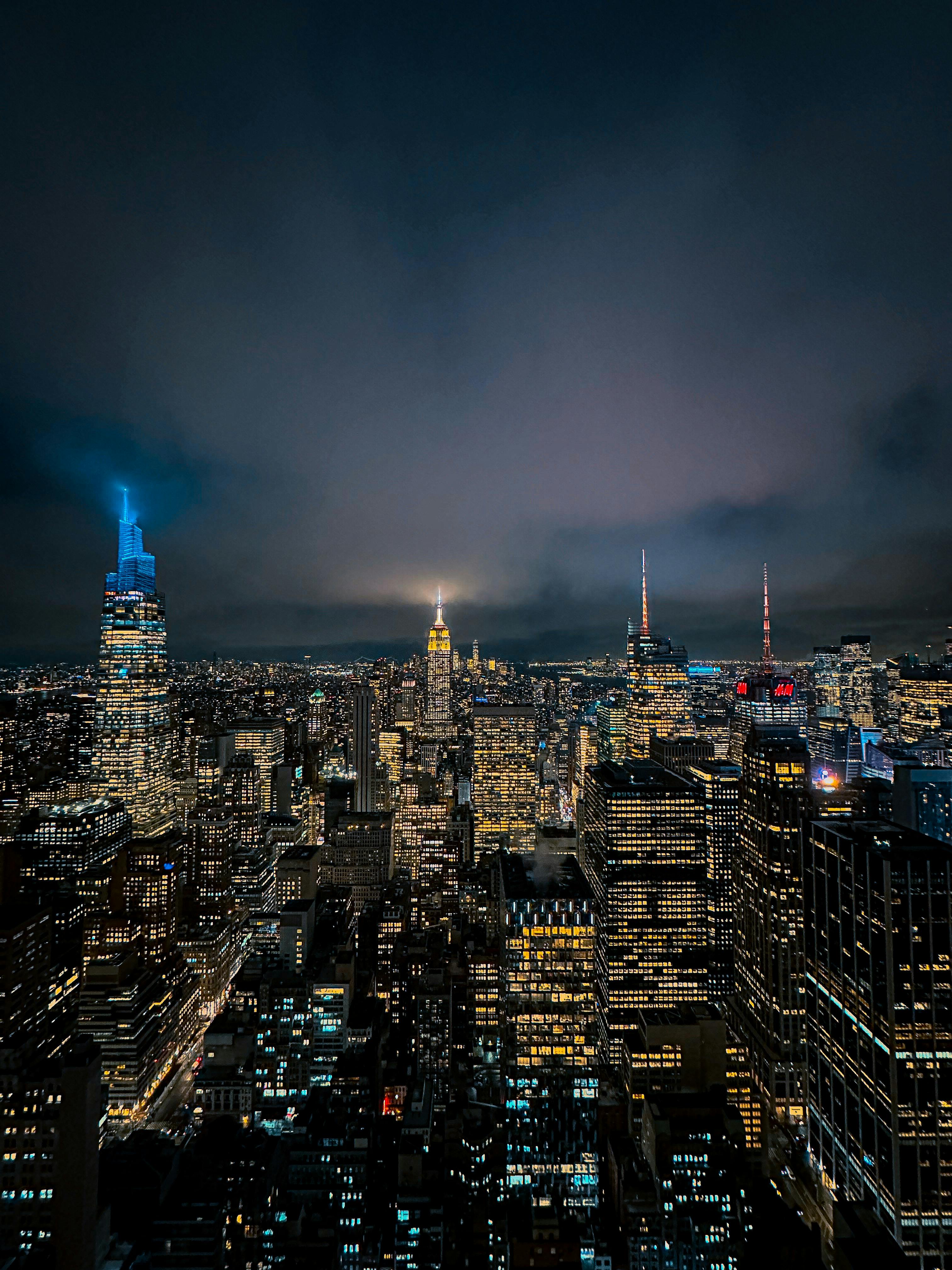 the city skyline at night with lights on