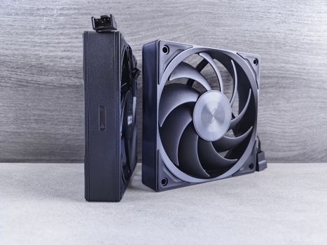 Side-by-side view of two high-performance computer cooling fans on a neutral background.