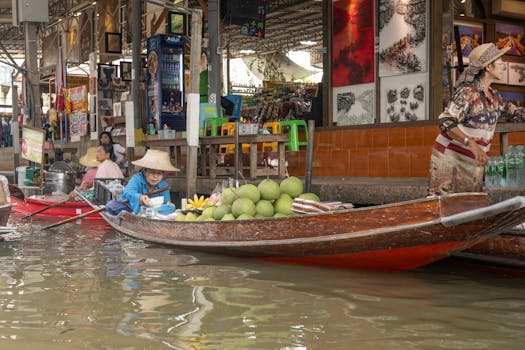 Colorful floating market with vendors selling fruits on boats in Bangkok.