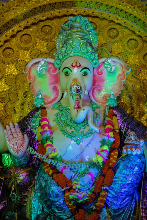 Free Stunningly decorated Ganesha idol with vivid colors and floral garlands, perfect for Indian festivals. Stock Photo