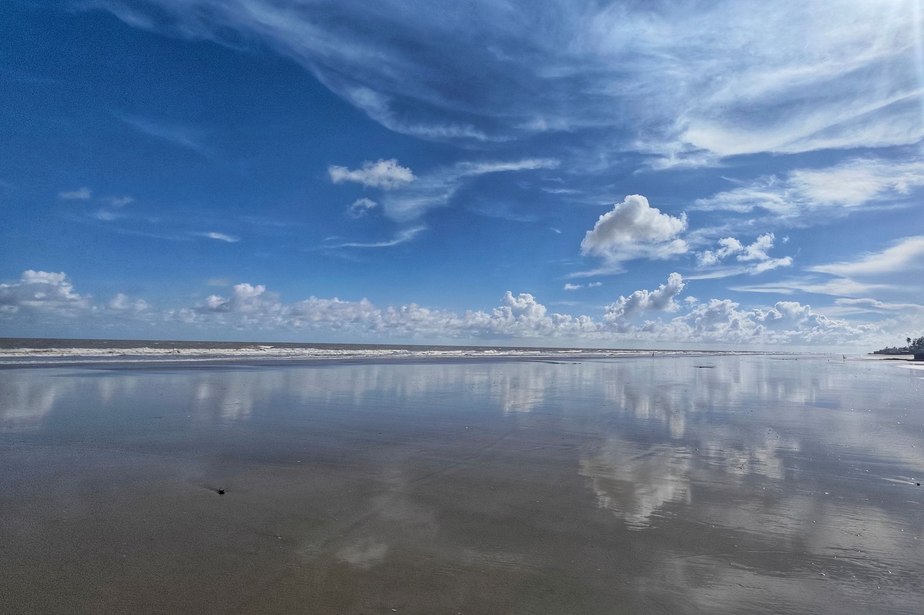 Beautiful photograph of reflections on a serene Mandarmani beach in West Bengal, India.