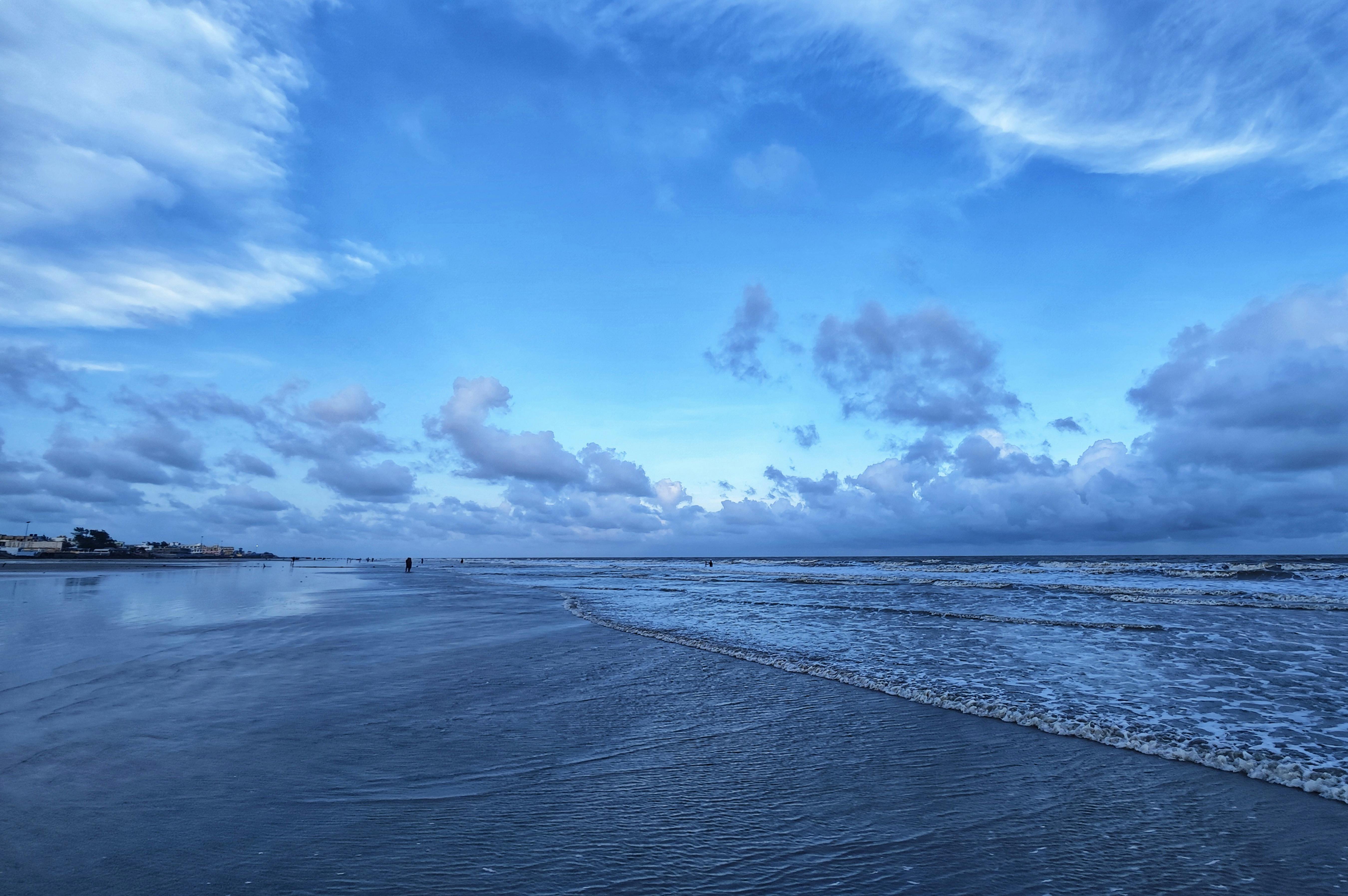 Relaxing seascape at Mandarmani beach, West Bengal, showcasing tranquil waves under a bright sky.