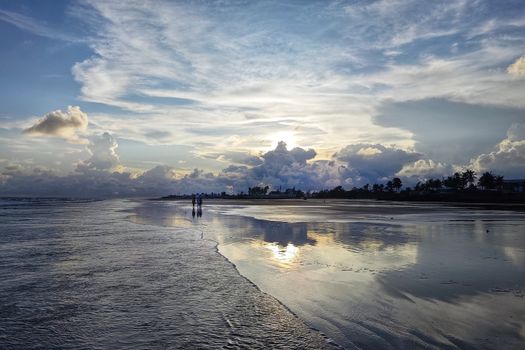 Beautiful beach sunset with reflections at Mandarmani, India. Ideal for travel and nature enthusiasts.