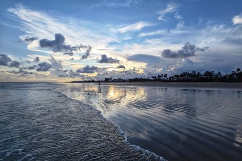 Free Captivating sunset over Mandarmani Beach with dramatic clouds and reflections. Stock Photo