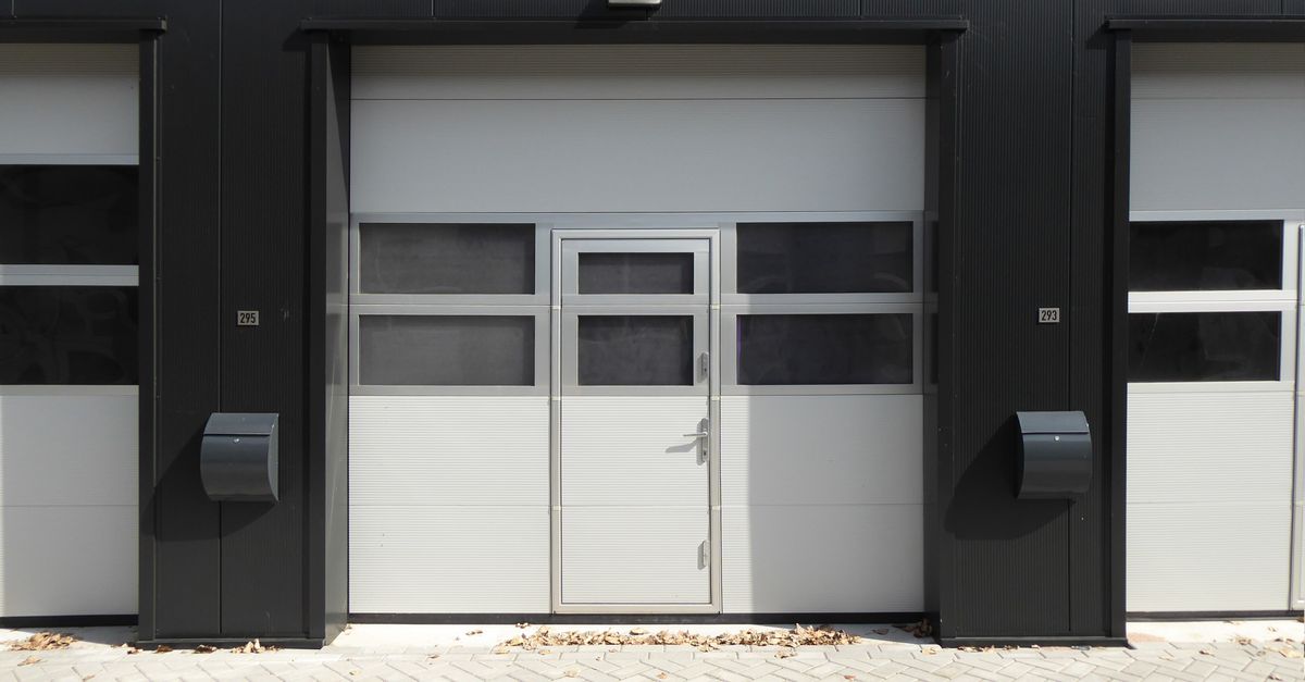 Modern industrial garage door with entrance, suitable for business property.