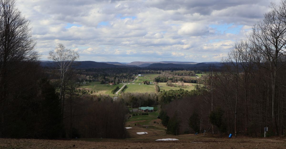 Picturesque landscape view in Morris, PA showcasing expansive fields under a cloudy sky.