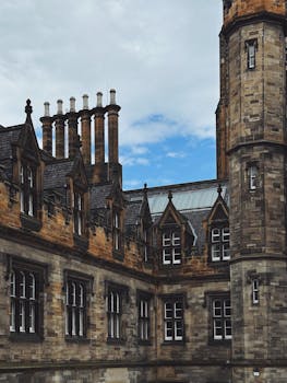 A moody, gothic building in Edinburgh showcasing historic stonework and chimneys.