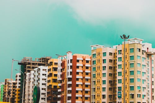 Free Assorted-color Buildings Under Green Sky Stock Photo