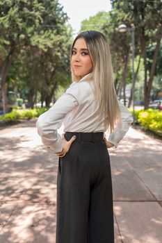 Confident woman in elegant attire posing outdoors in Ciudad de México.
