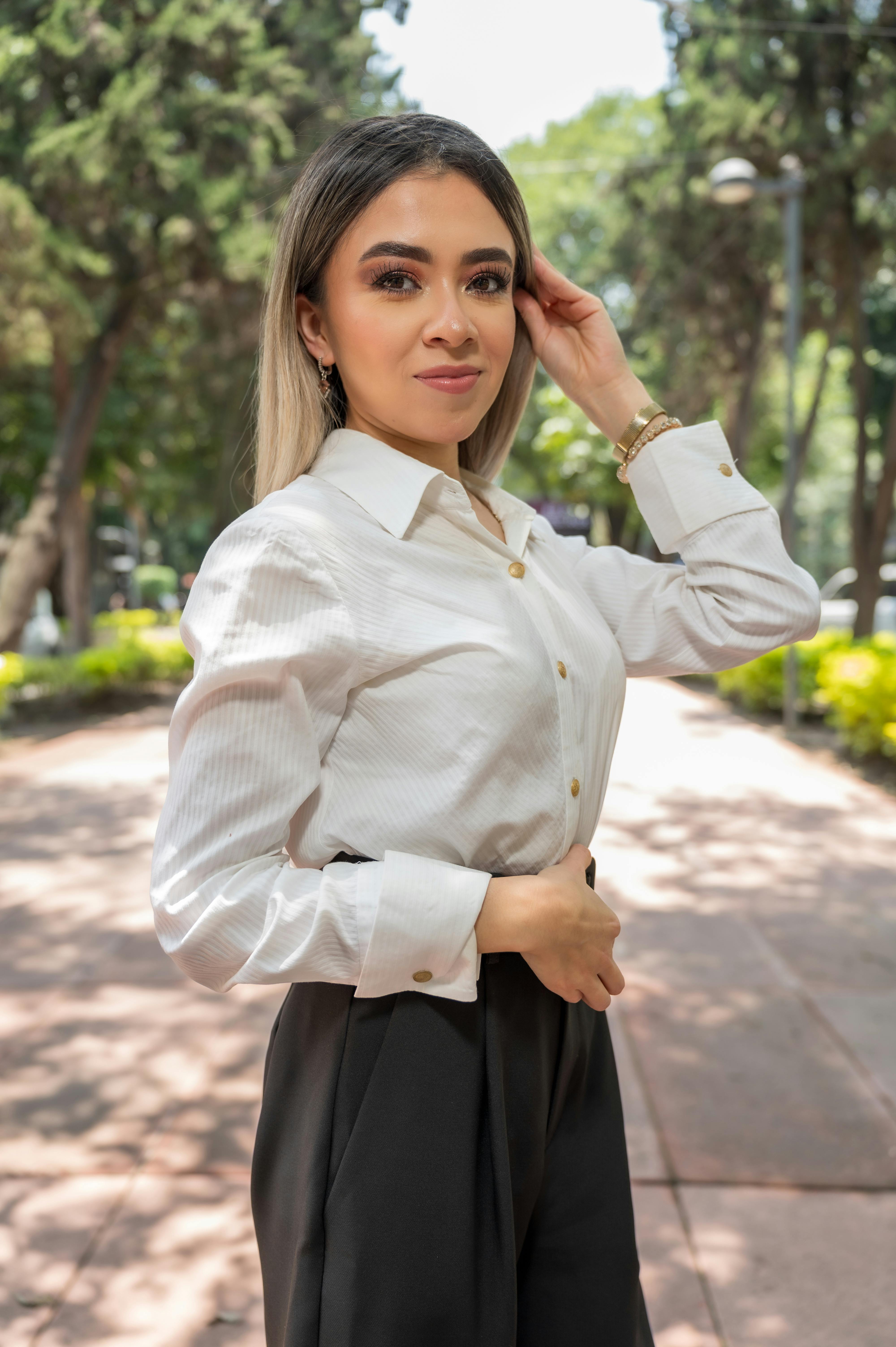 a woman in a white shirt and black pants