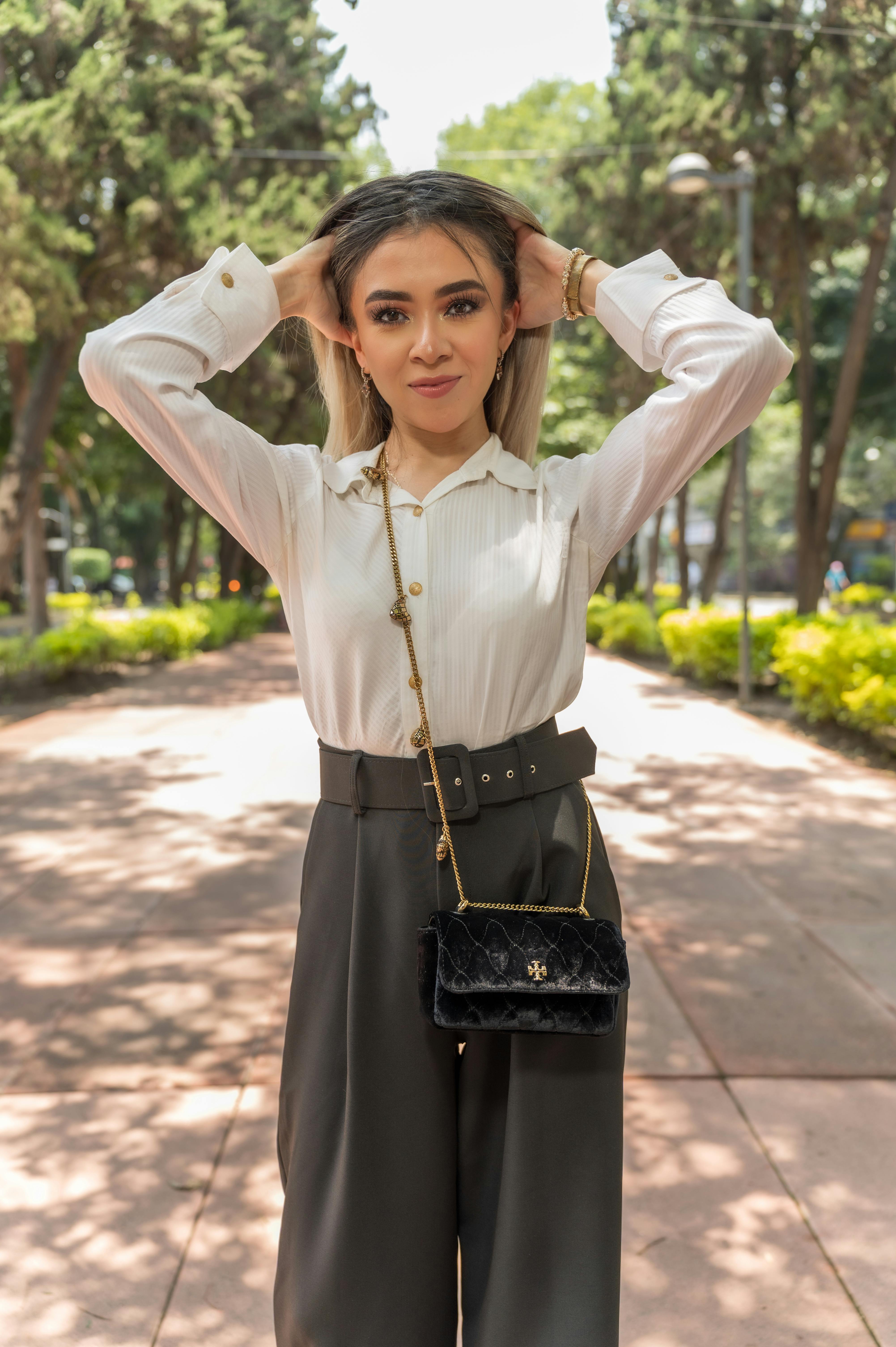 a woman in a white shirt and black pants