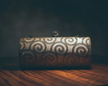 A luxurious beaded clutch purse featuring an intricate swirl pattern, perfect for evening events.