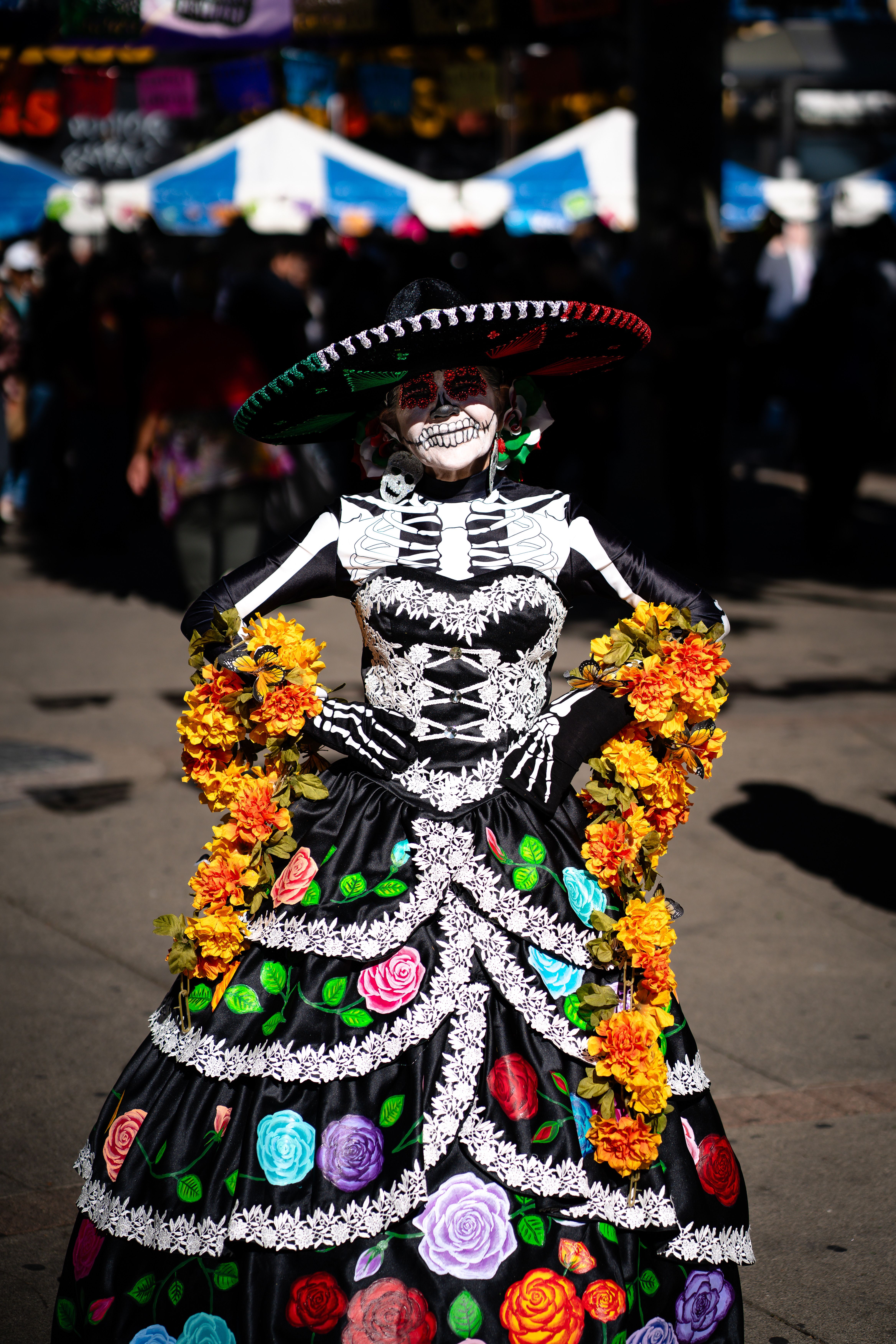 A woman dressed in a skeleton costume stands in the street · Free Stock ...