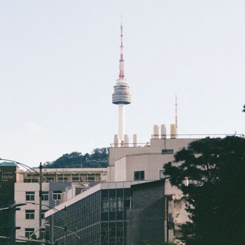 Free A scenic view of Namsan Seoul Tower rising above modern buildings in the cityscape. Stock Photo