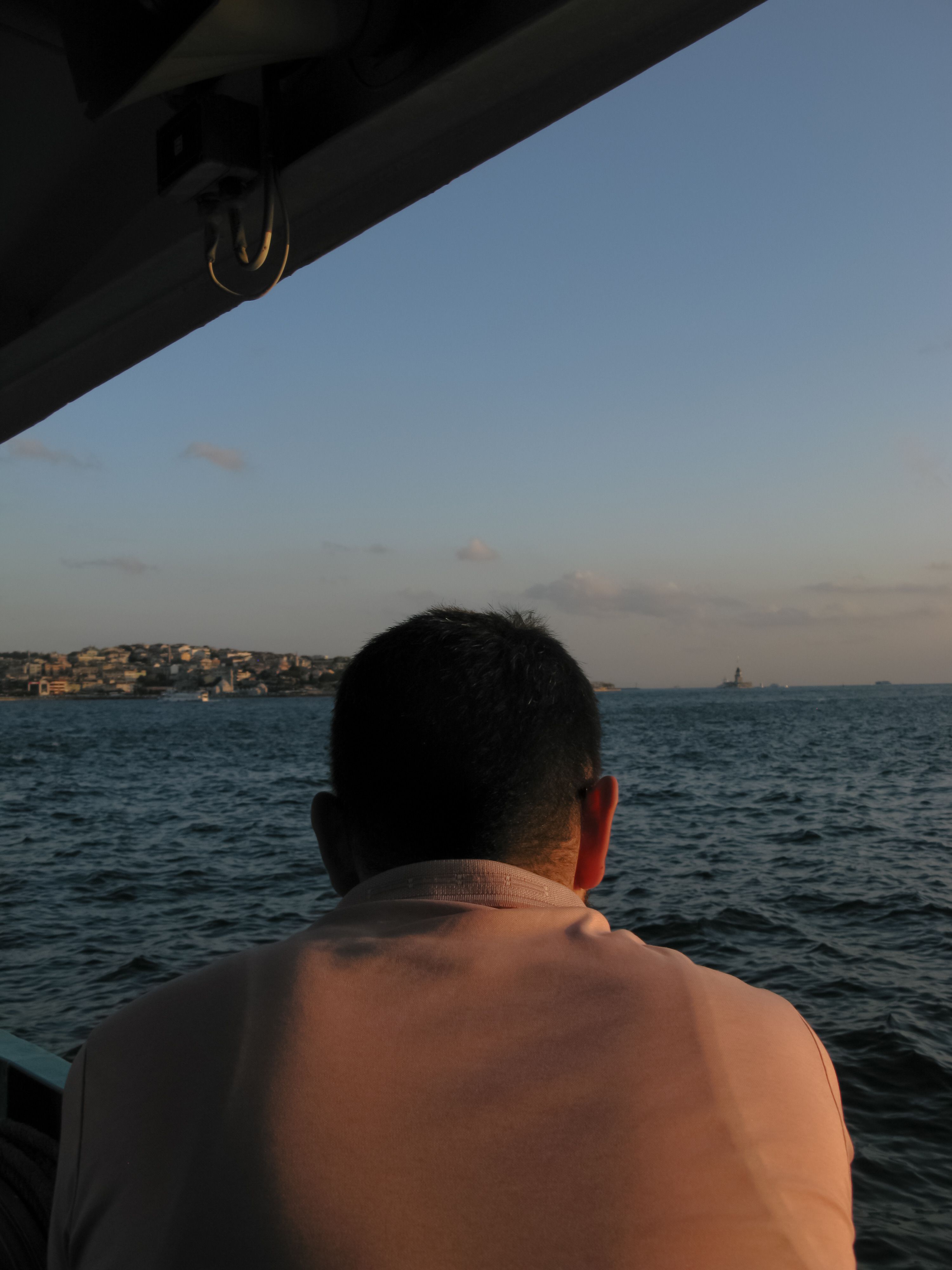 Contemplative Man Overlooking Ocean Sunset · Free Stock Photo