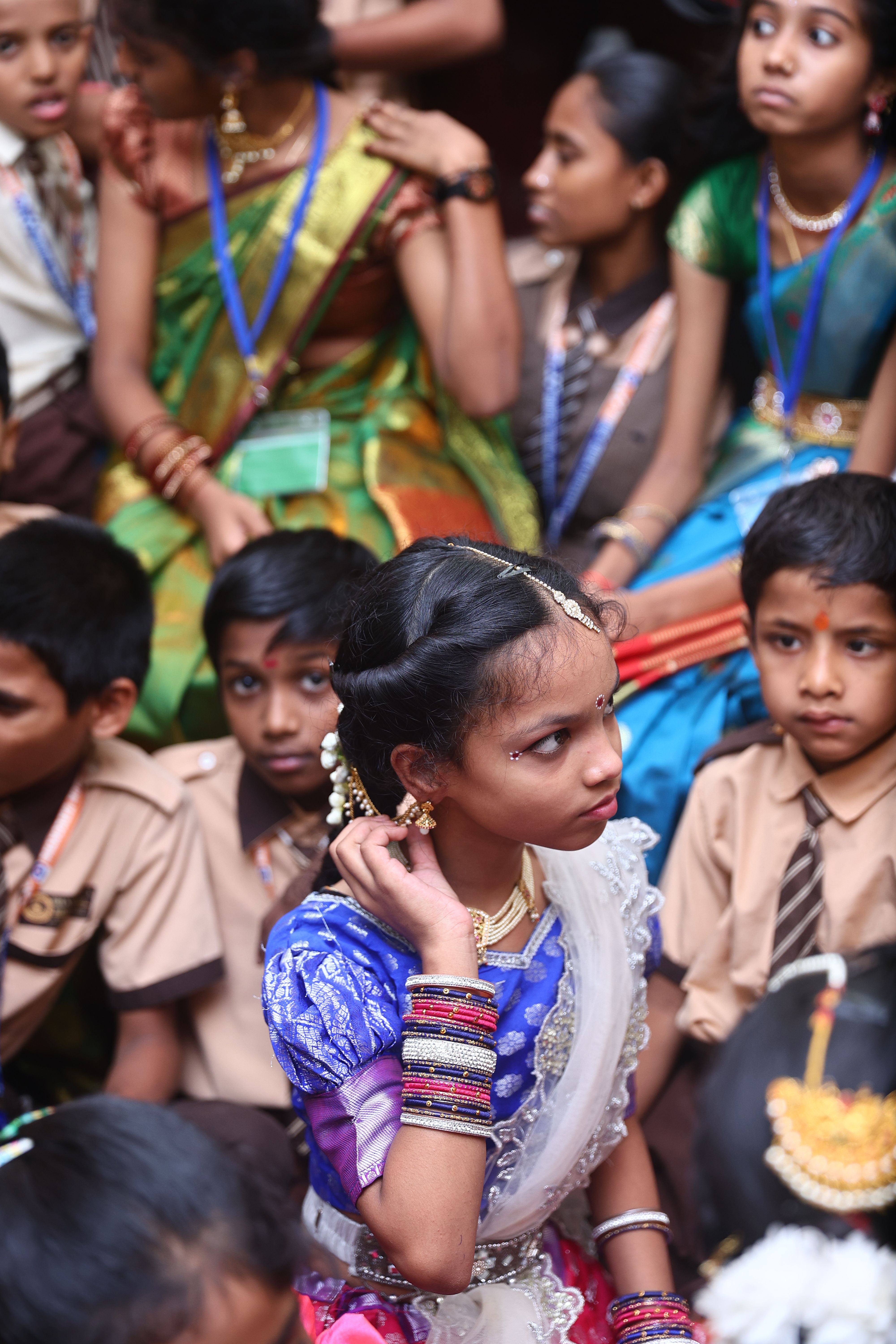 A wide view of a cultural performance by students in traditional Indian attire.