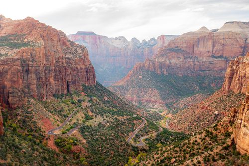 Free Stunning aerial view of the winding road through Zion National Park's majestic canyon landscape. Stock Photo