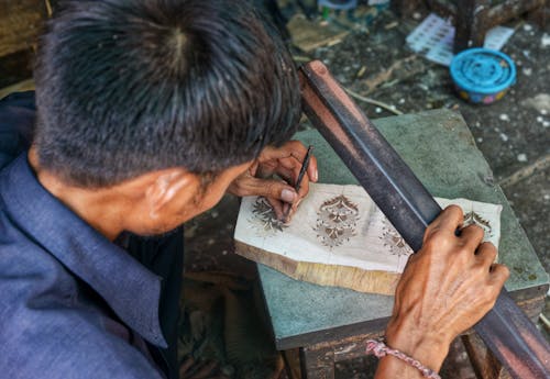 Free Detailed view of an artisan crafting a wooden block for textiles in Jaipur, India. Stock Photo