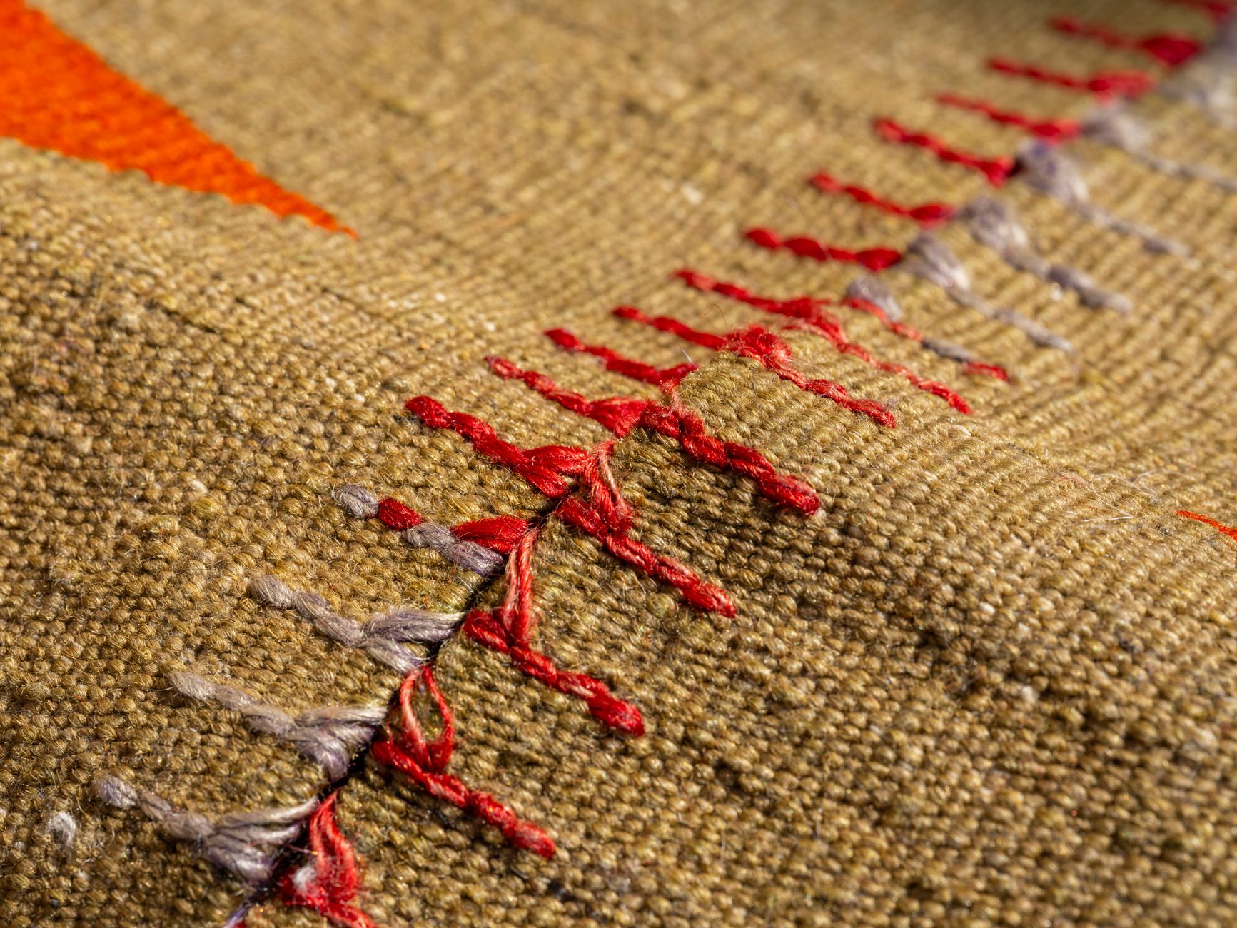 Detail of a freshly cleaned woven wool rug showing crisp pattern and color