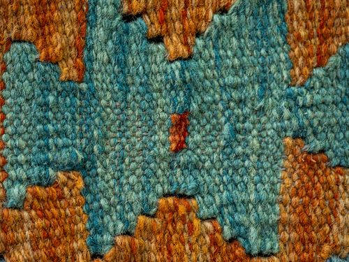 Free Detailed macro view of a colorful handwoven textile with intricate patterns. Stock Photo