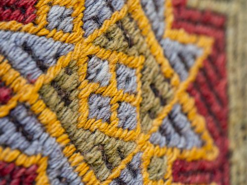 Free Detailed close-up of a vibrant woven textile pattern with intricate design. Stock Photo
