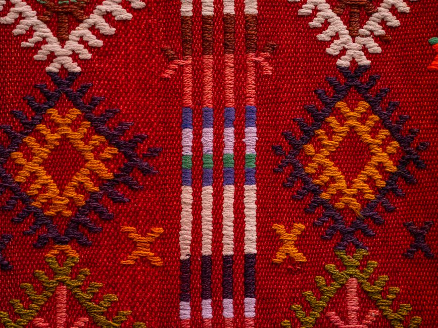 Close-up of a colorful and traditional Turkish Kilim textile pattern showcasing intricate woven designs.