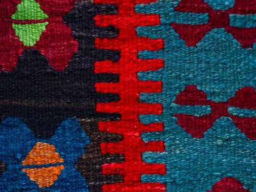 Free Close-up of a colorful traditional woven kilim textile showcasing intricate patterns and vibrant colors. Stock Photo