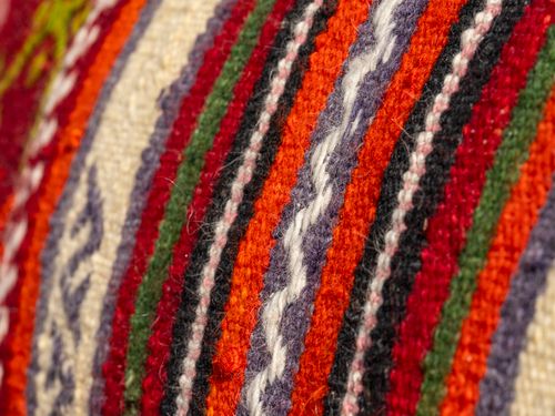Free Close-up view of a colorful woven textile with bold striped patterns showcasing intricate fiber textures. Stock Photo