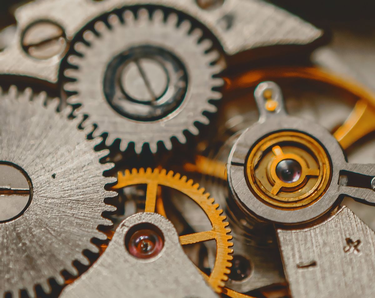 Macro view of brass and steel watch movement gears — photo by Oleksandr K on Pexels