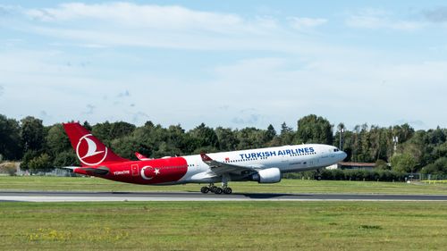 Free Turkish Airlines airplane taking off at Hamburg airport on a clear day. Stock Photo