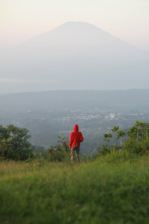 Person Standing on Top of Mountain