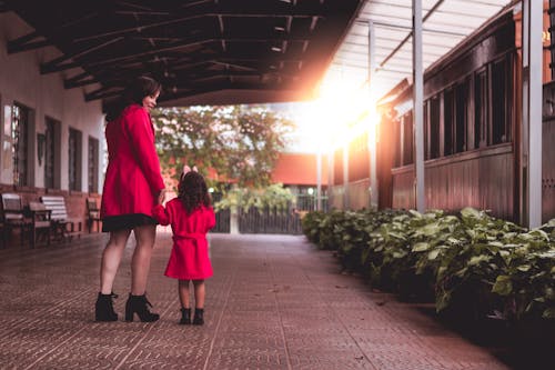 Woman Holding Toddler on Pathway