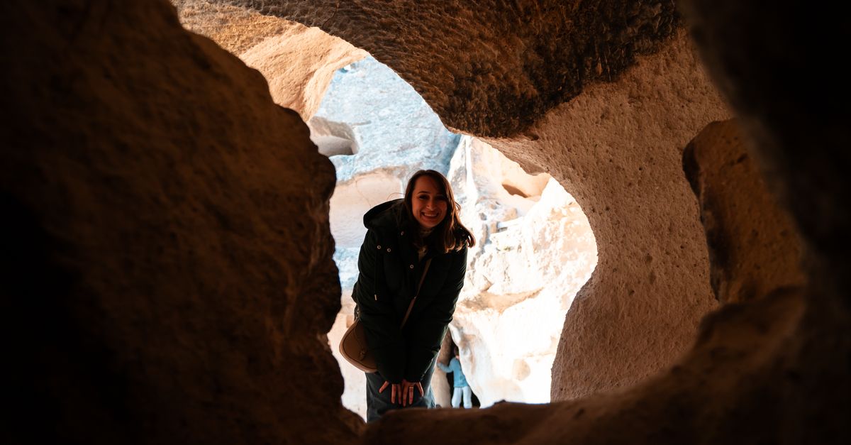 Exploring Rok Woman Exploring Rock Formations in Cave · Free Stock Photo