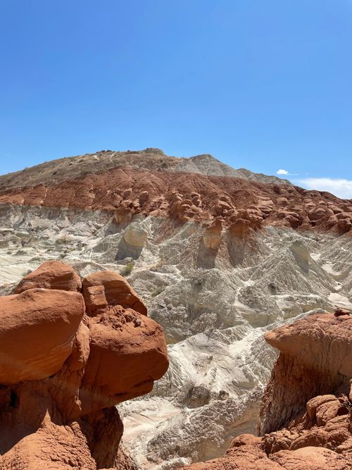 Free Stunning view of layered red and white rocks with vivid blue sky in a desert landscape. Stock Photo