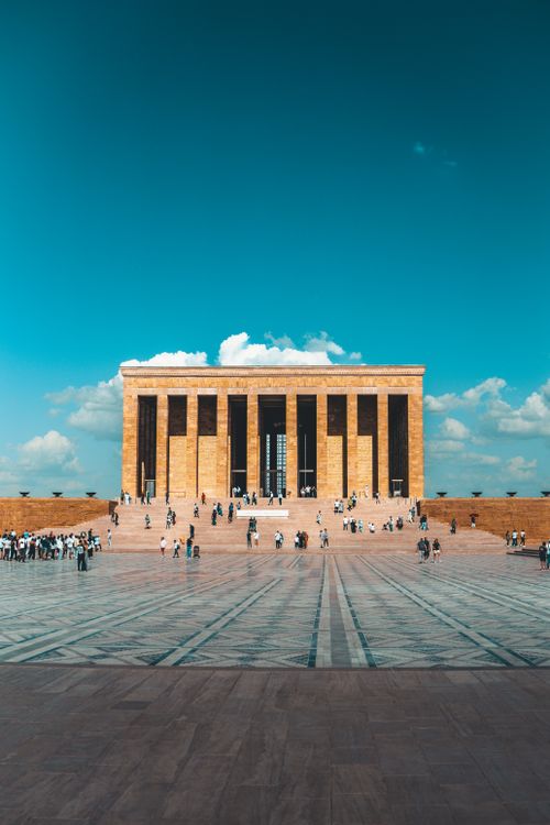 Free Anıtkabir monument in Ankara with people gathered in front under a clear blue sky. Stock Photo
