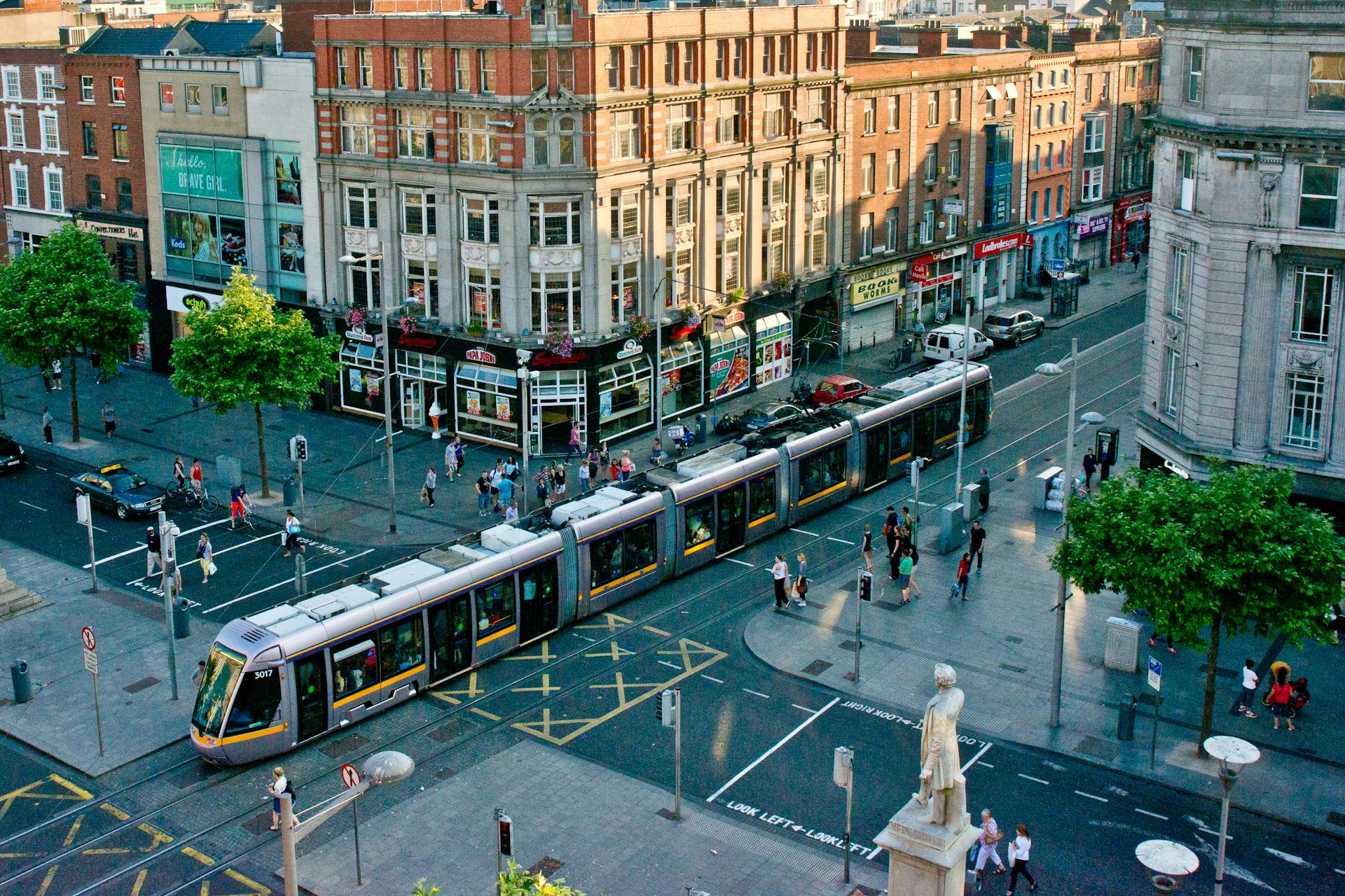 Vibrant scene of Dublin city center showcasing tram and bustling streets from above.