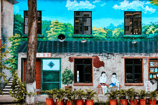 Vibrant mural depicting nature and people on a building exterior.