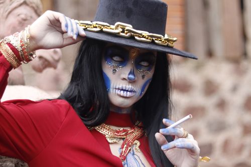 Free Captivating Day of the Dead makeup art with ornate attire and vibrant colors. Stock Photo