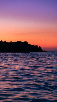Gorgeous sunset with vivid colors and gentle ocean waves, creating a calming atmosphere.
