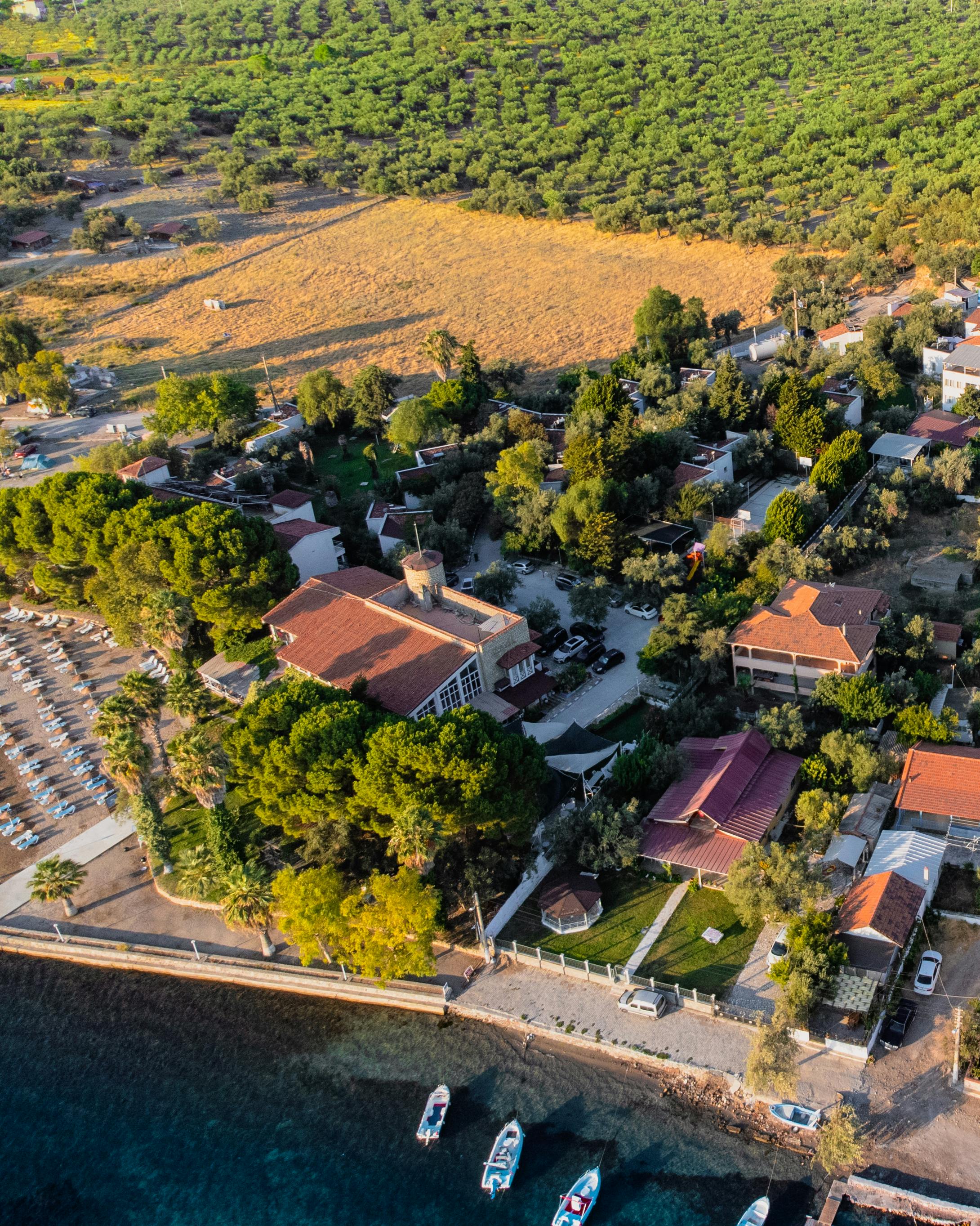 A stunning aerial view of a coastal town surrounded by lush greenery and calm waters.