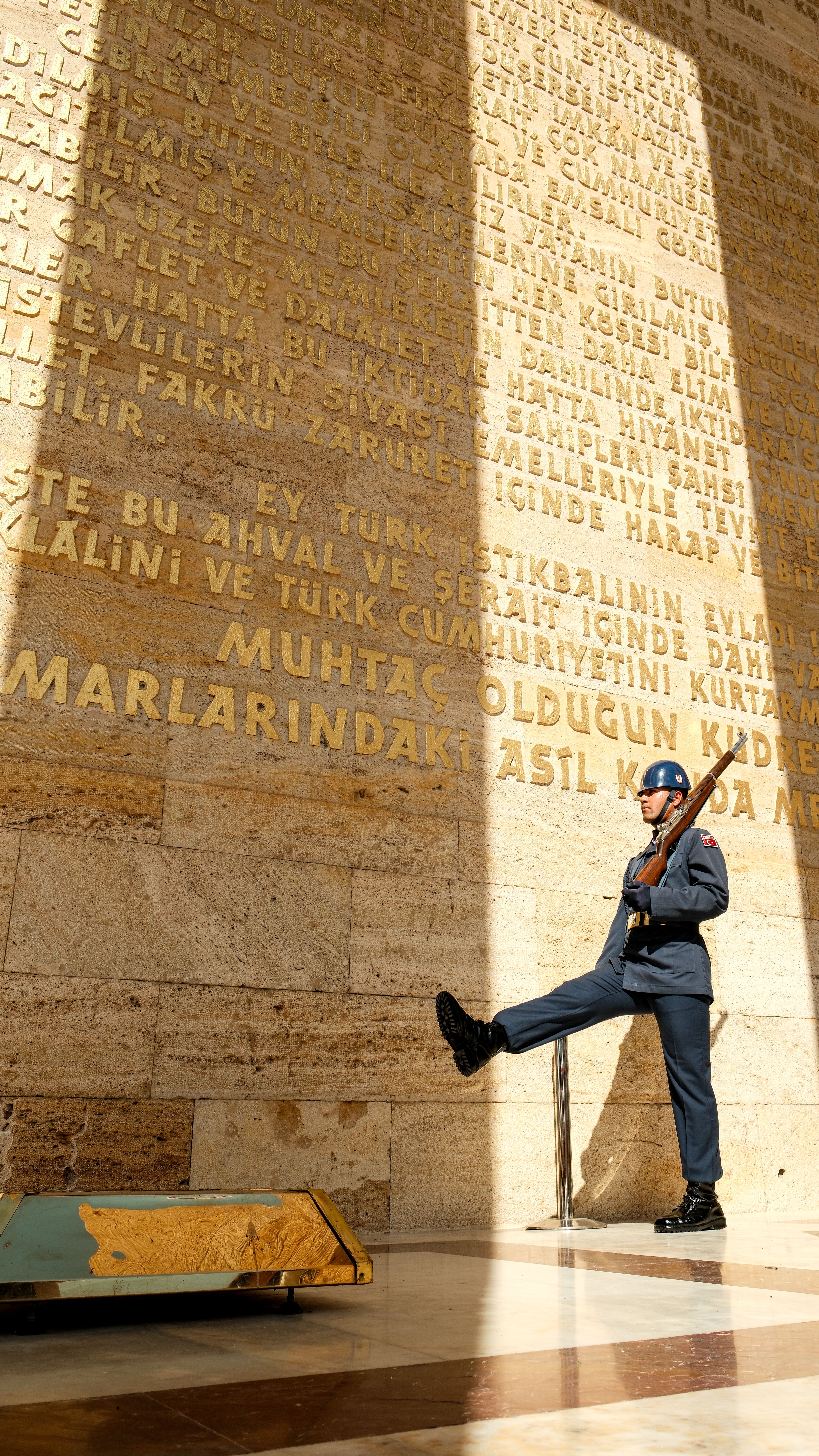 A ceremonial guard stands solemnly at a monument in Ankara, capturing a moment of honor and tradition.